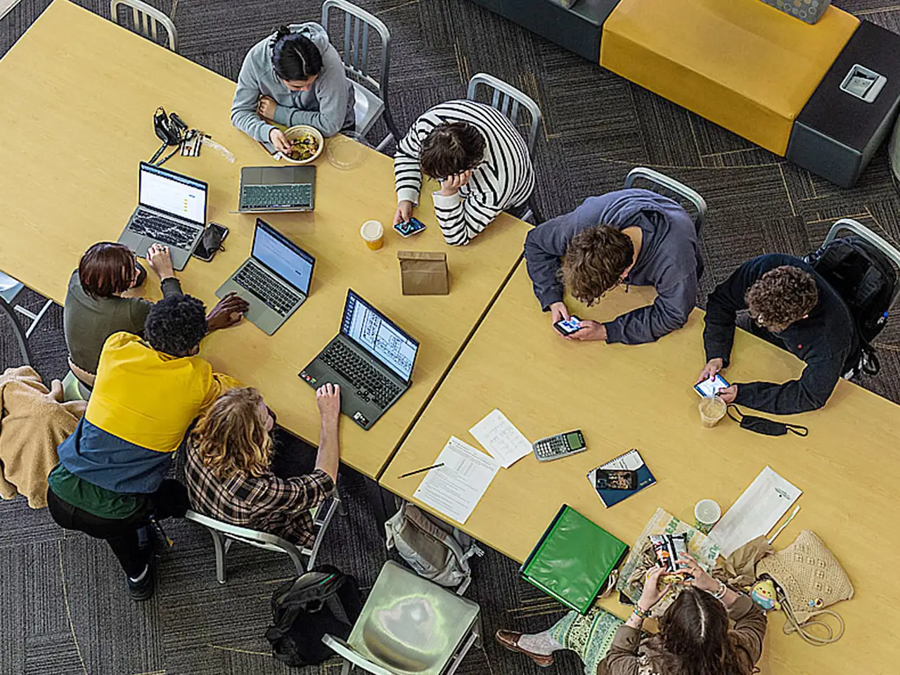 Students working together at a large table.