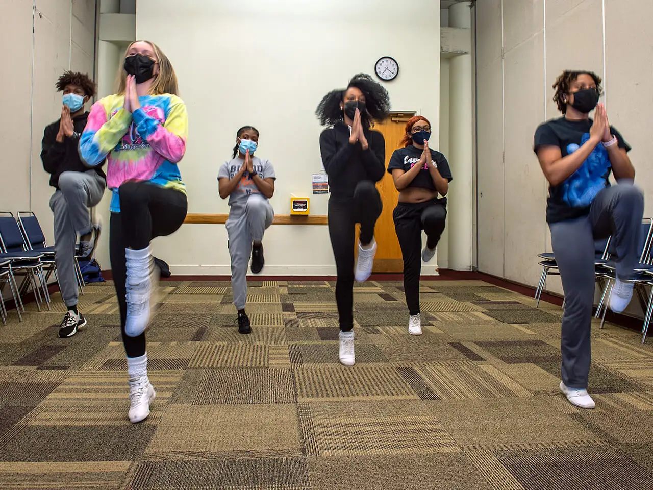 Group of women practice dancing.