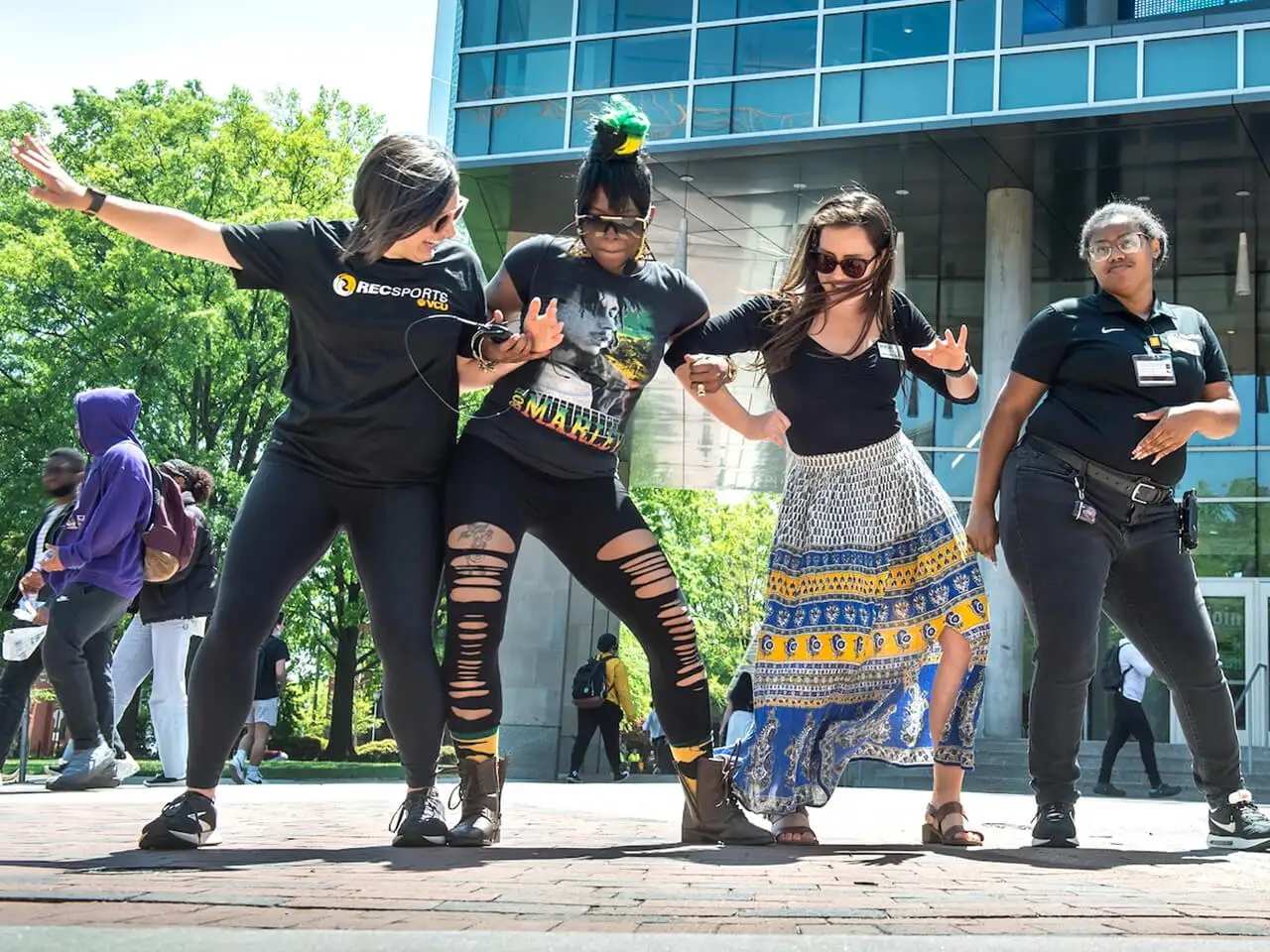 Students enjoying the nice weather dancing together.