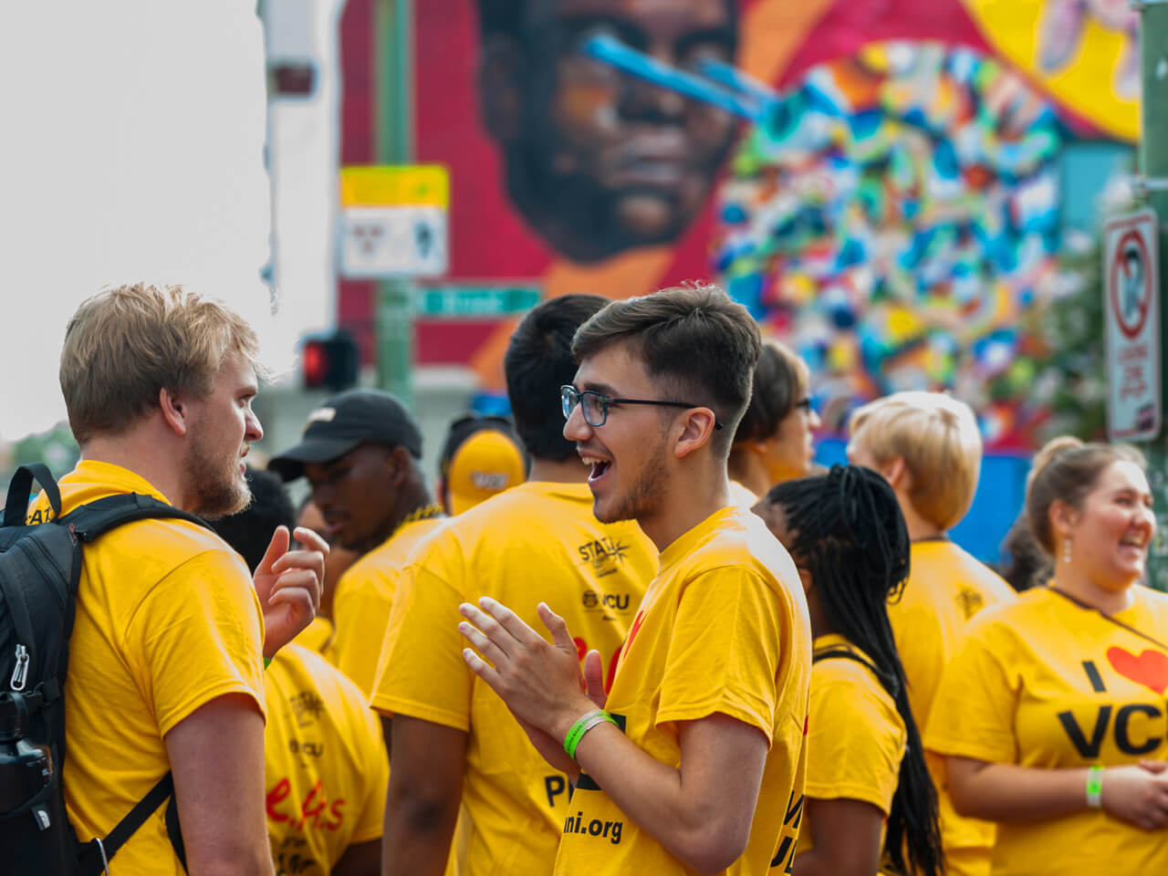 Students in vcu gold shirts outdoors at an event