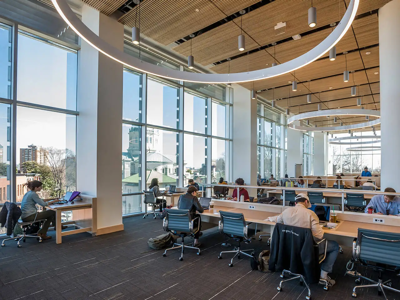 Students studying at tables in the library.