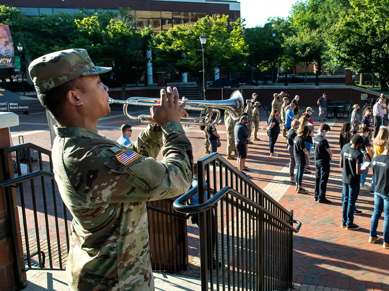 Person in military uniform playing the trumpet.