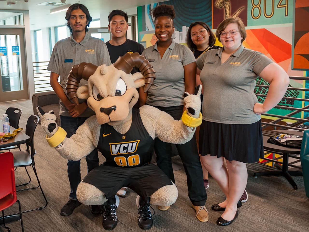 Rodney the Ram posing with a group of volunteers