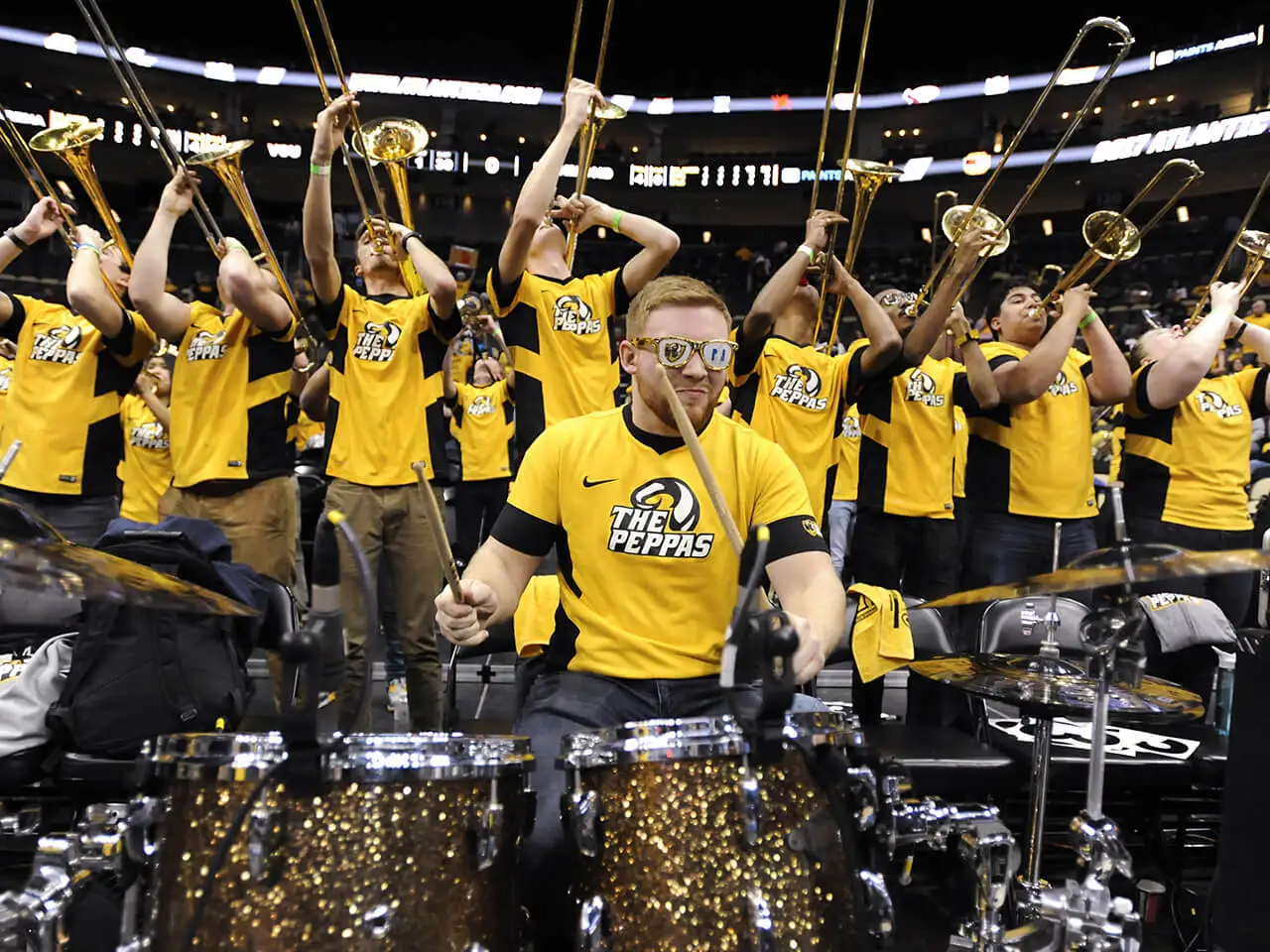 Pep band plays music at a sporting event.