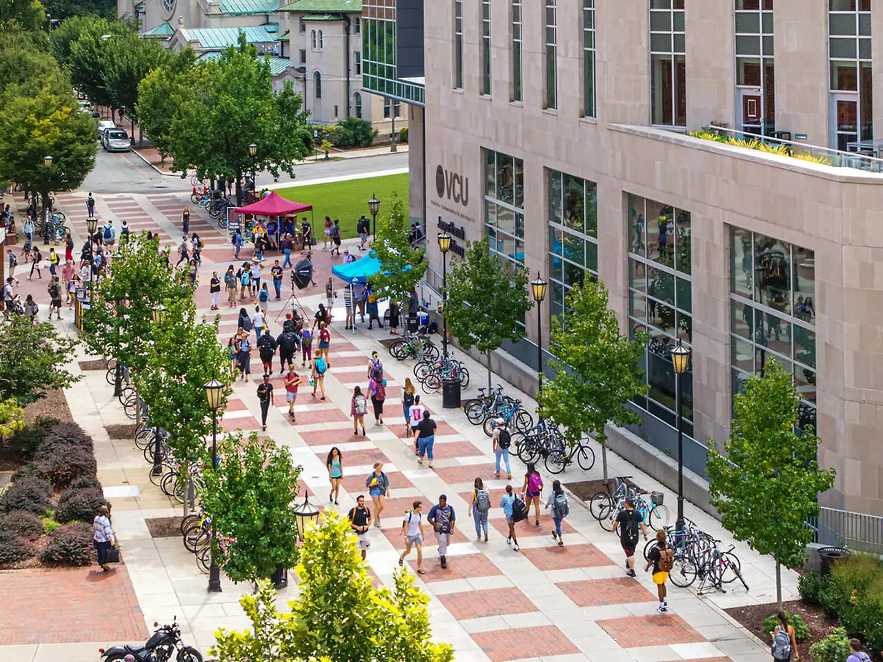 Students walking by the library towards the compass.