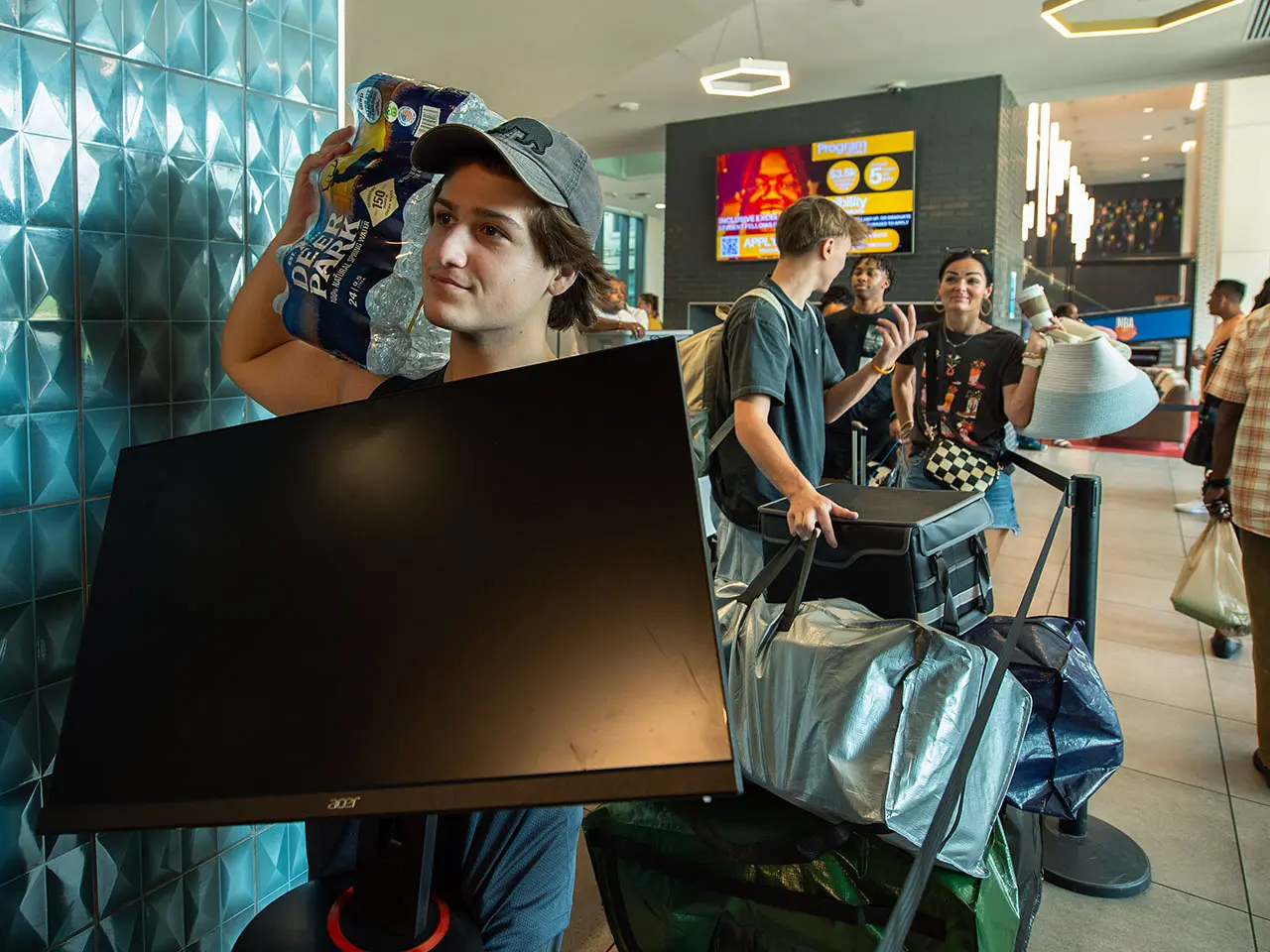 Students on move in day carrier items for their room