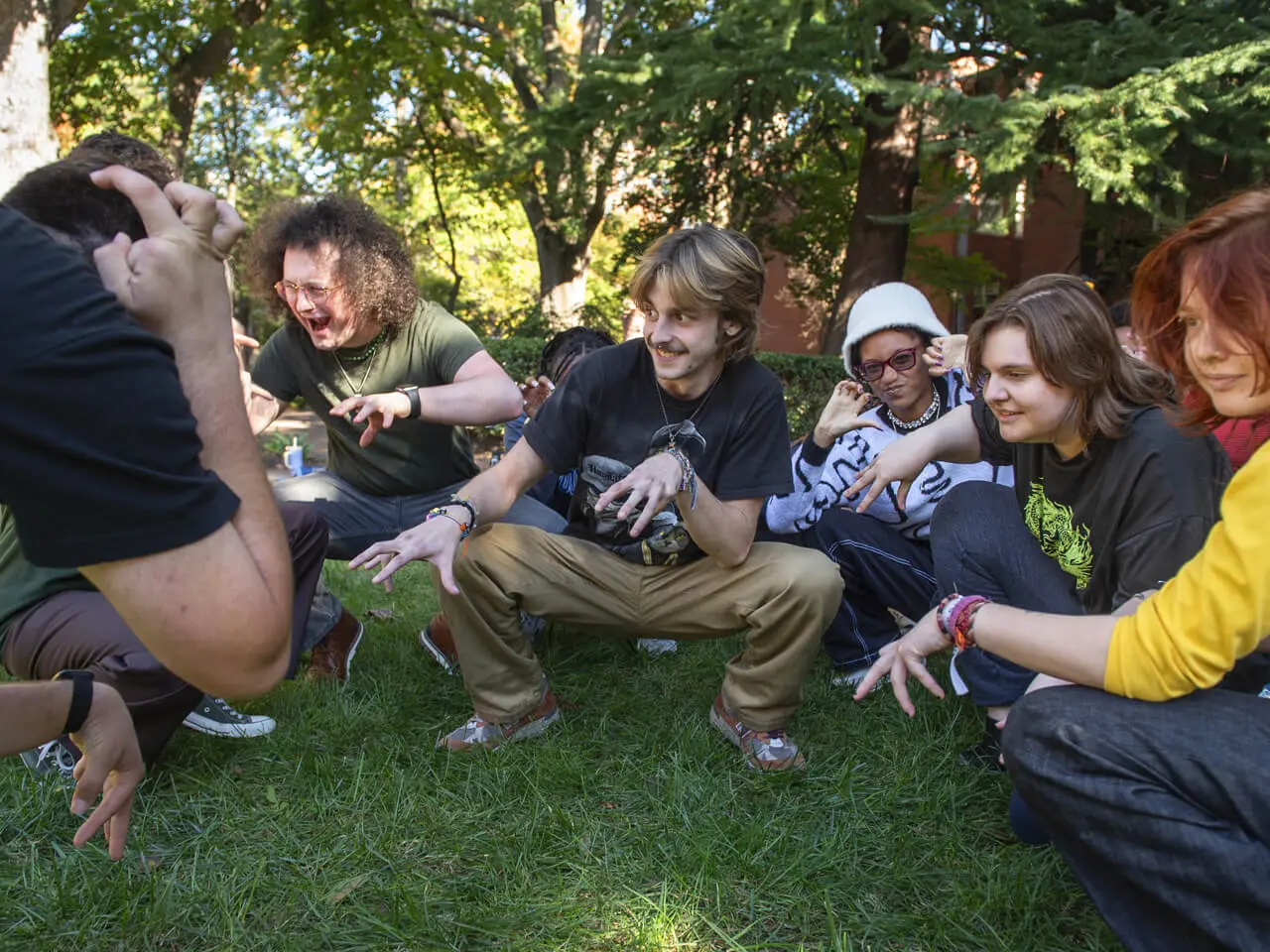 A group of students does an improv warmup