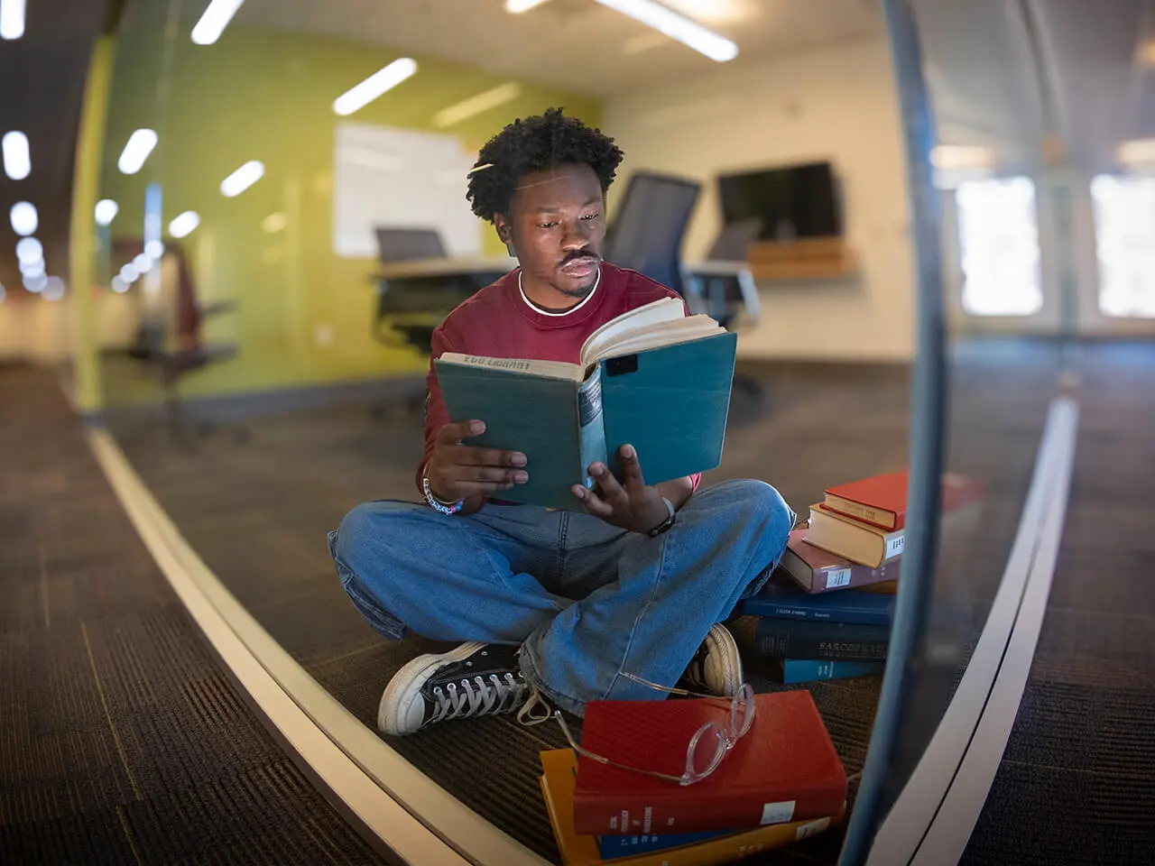 A student sits in a pod that helps reduce noise for studying