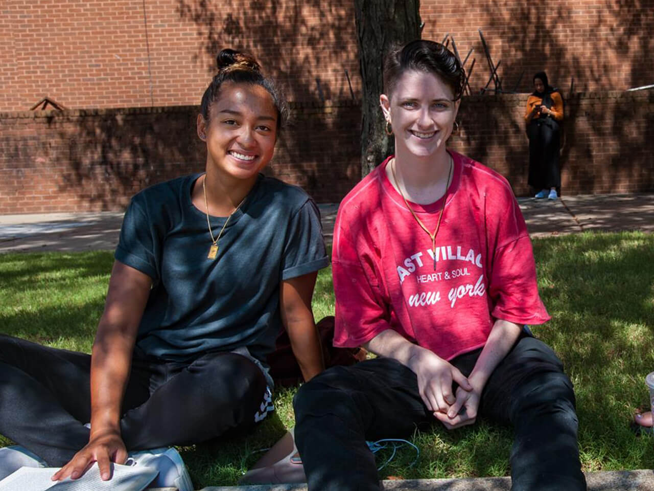 Two students sitting together outside