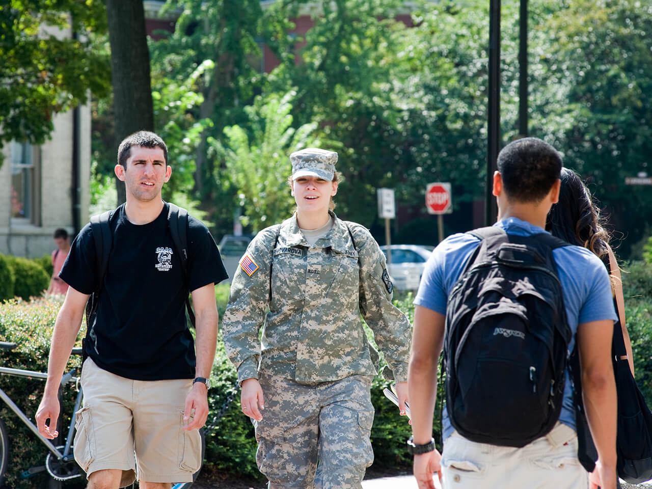 Student in military clothing walking with another student