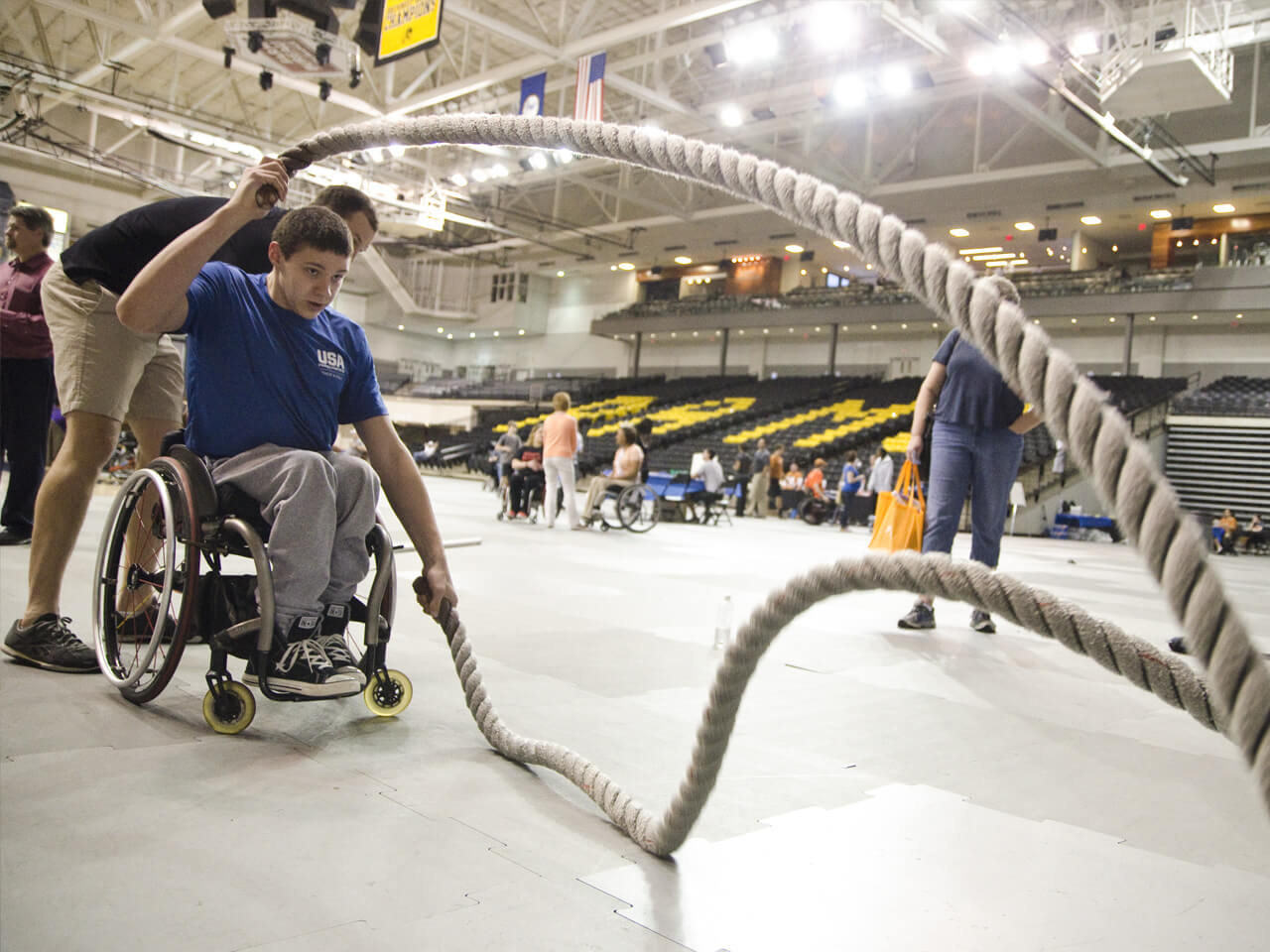 Person in a wheelchair exercises with ropes